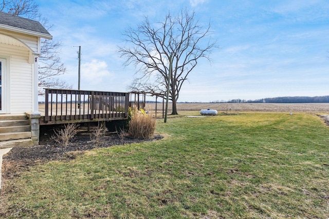 view of yard with a rural view and a wooden deck