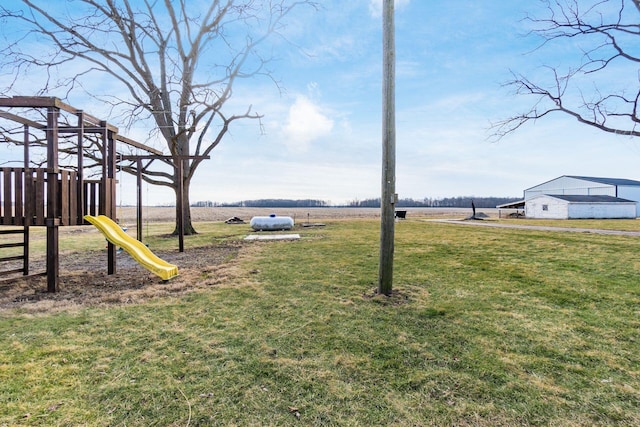 view of yard with a playground and a rural view