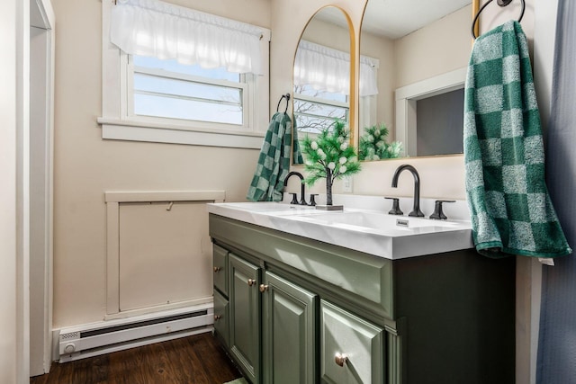 bathroom featuring a baseboard radiator, hardwood / wood-style floors, and vanity