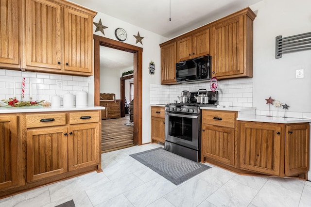 kitchen featuring backsplash and stainless steel gas stove