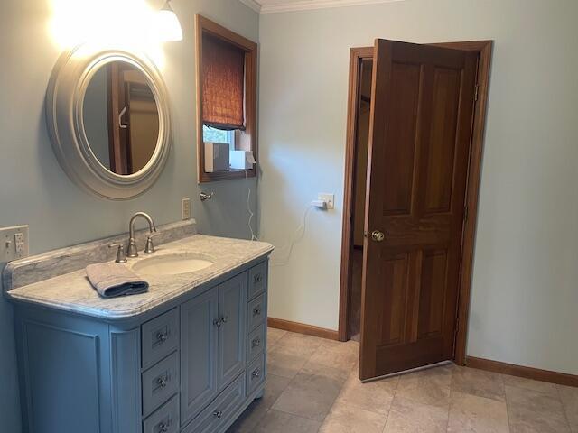 450 Yale Ave, Lima, OH 45804 - bathroom with crown molding, baseboards, and vanity