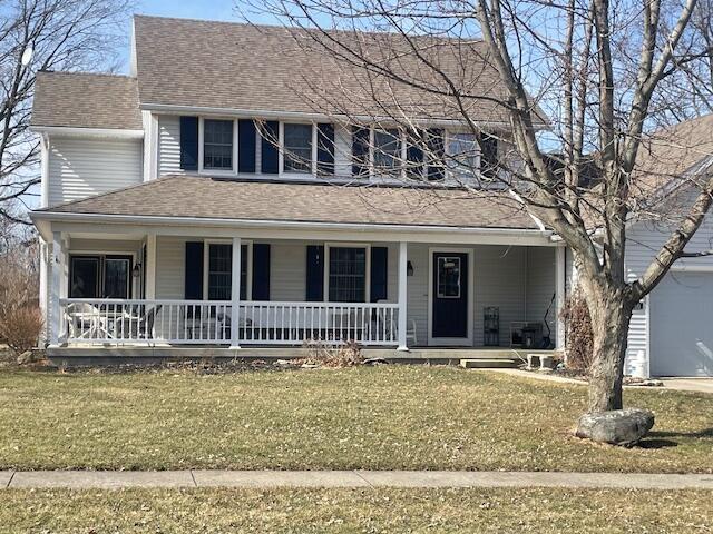 view of front of home with a front lawn, a porch, and roof with shingles