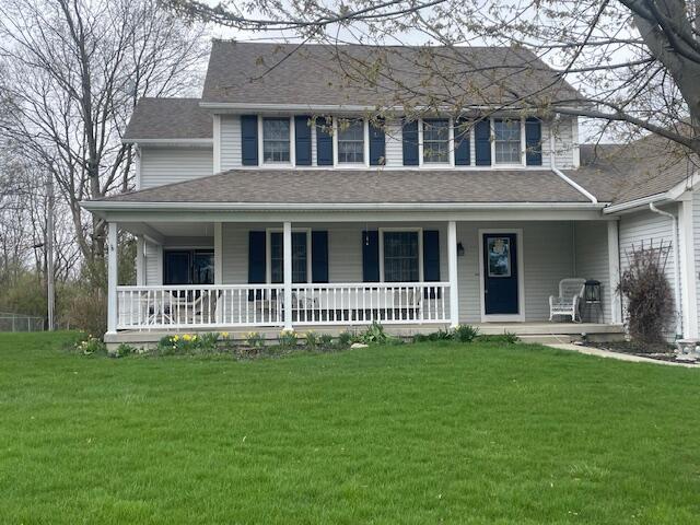 450 Yale Ave, Lima, OH 45804 - farmhouse-style home with a front lawn, a shingled roof, and a porch