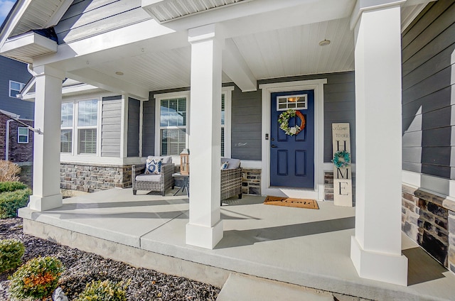 view of exterior entry with covered porch