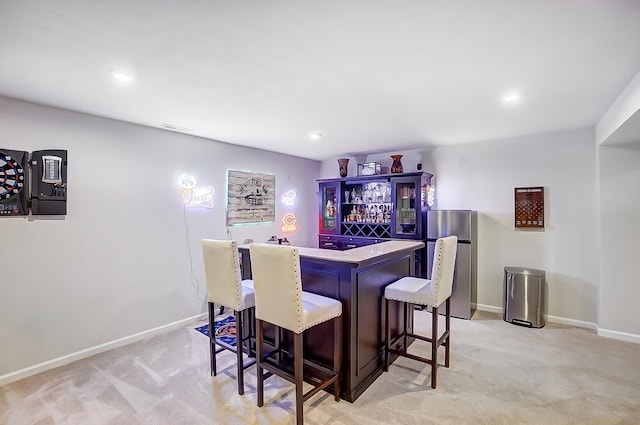 bar with light colored carpet and stainless steel fridge