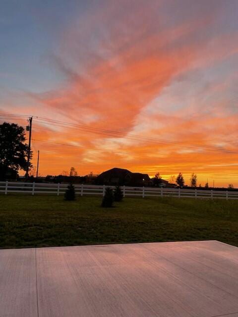 yard at dusk with a rural view