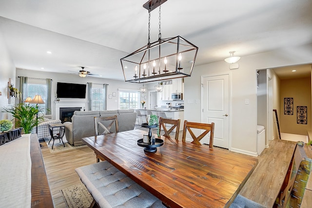 dining space featuring light hardwood / wood-style floors and ceiling fan