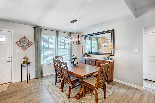 dining area with plenty of natural light and light wood-type flooring