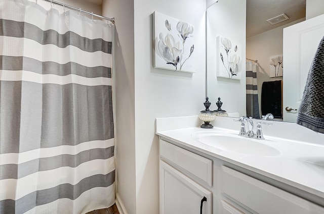 bathroom with vanity and a shower with shower curtain