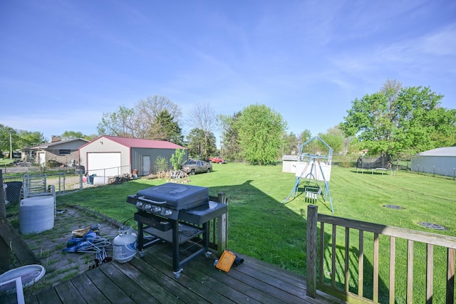 wooden terrace featuring a garage, area for grilling, a playground, a lawn, and a trampoline