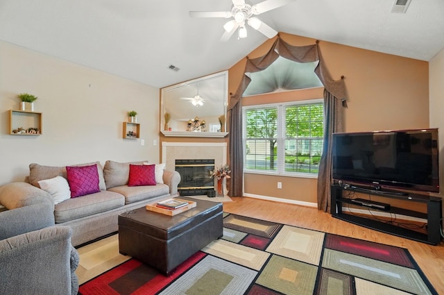 2696 Prestwick Village Cir, Springfield, OH 45503 - living area featuring a ceiling fan, wood finished floors, a tiled fireplace, and vaulted ceiling