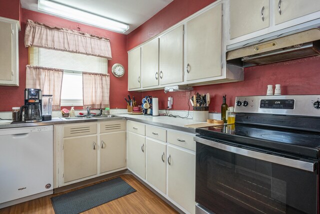 5385 Woodbine Ave, Dayton, OH 45432 - kitchen with stainless steel range with electric stovetop, dishwasher, extractor fan, light wood-style floors, and light countertops