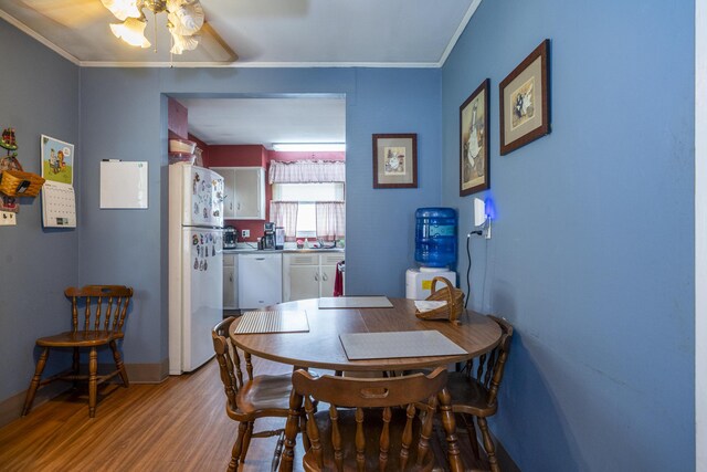 5385 Woodbine Ave, Dayton, OH 45432 - dining area with light wood-style flooring, ornamental molding, and a ceiling fan