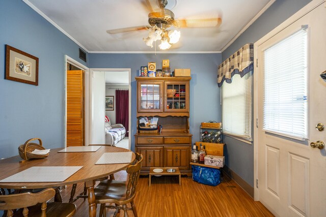 5385 Woodbine Ave, Dayton, OH 45432 - dining space featuring wood finished floors, ceiling fan, and crown molding