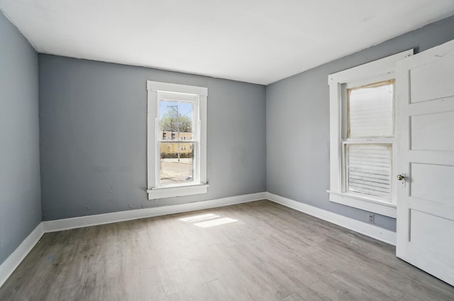 empty room featuring wood finished floors and baseboards