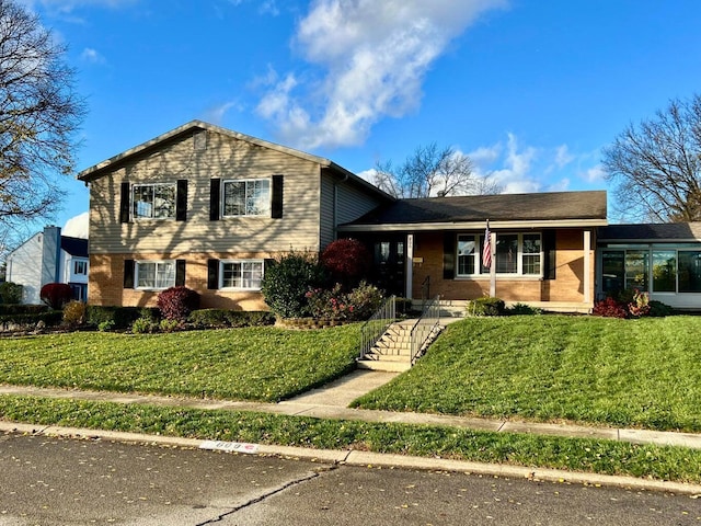 tri-level home with a front lawn