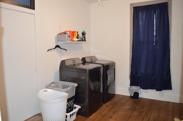 laundry area featuring washer and dryer, laundry area, and wood finished floors