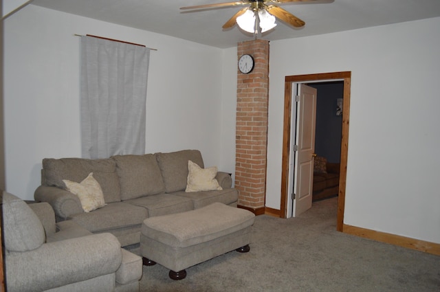 carpeted living room featuring ceiling fan and baseboards