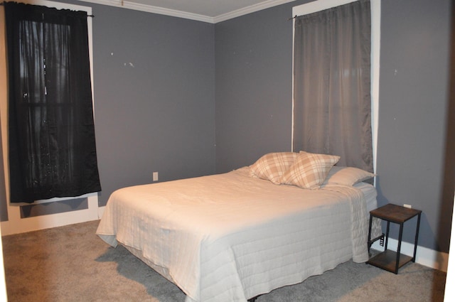 bedroom with ornamental molding and carpet