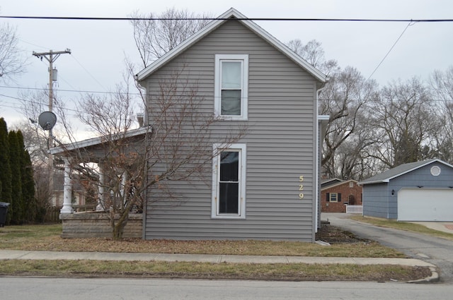 view of side of home with an outbuilding