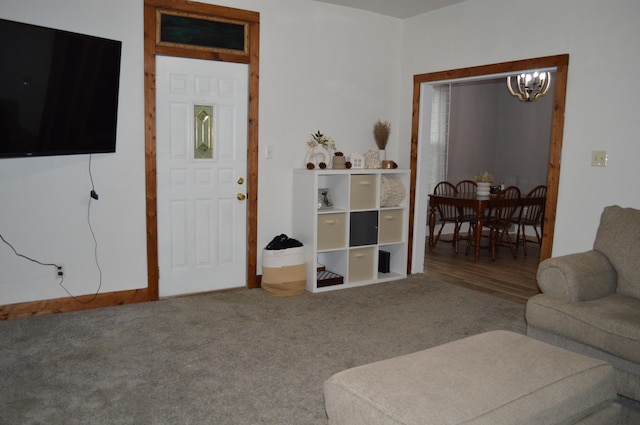 carpeted living area featuring an inviting chandelier