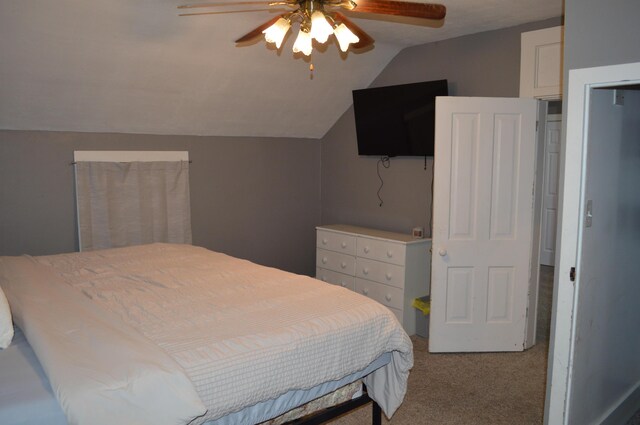 carpeted bedroom with a ceiling fan and lofted ceiling