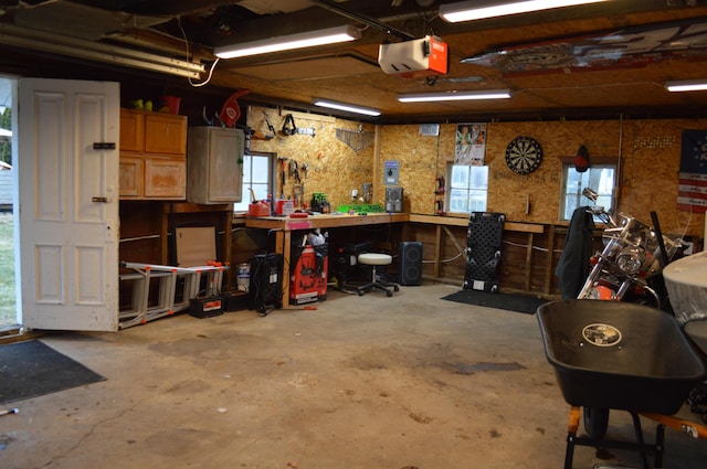 garage with a workshop area and a garage door opener