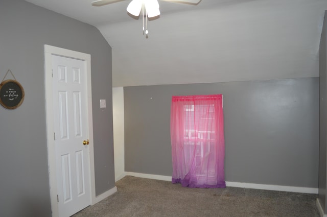 additional living space featuring a ceiling fan, baseboards, vaulted ceiling, and carpet flooring