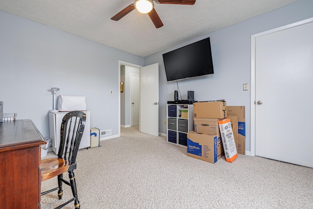 home office with carpet, a textured ceiling, baseboards, and ceiling fan