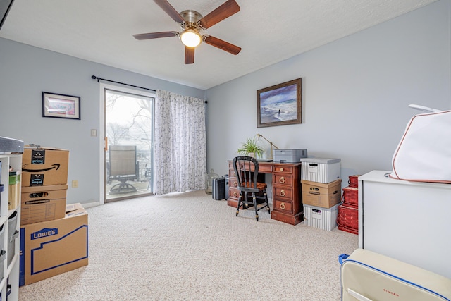 home office featuring a ceiling fan and carpet