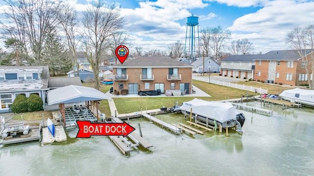 view of dock with a lawn and boat lift