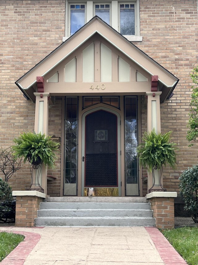 property entrance featuring brick siding