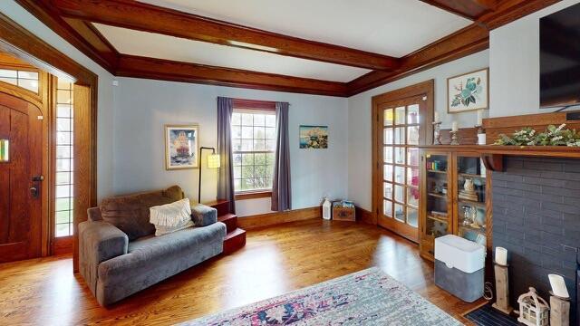 living area featuring wood finished floors and beam ceiling