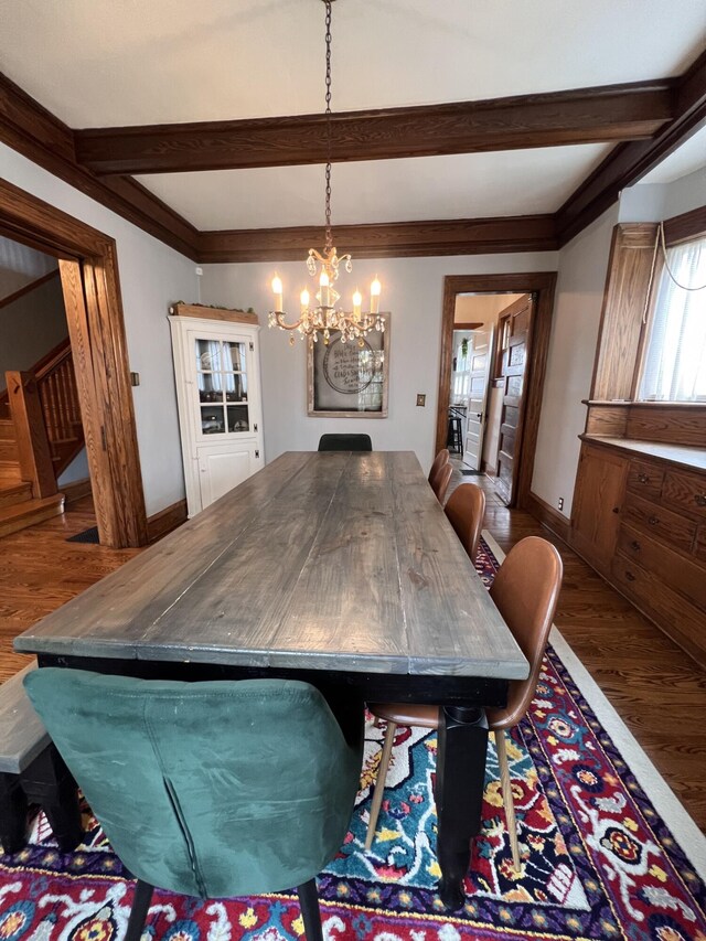 dining space with stairway, wood finished floors, an inviting chandelier, baseboards, and beam ceiling
