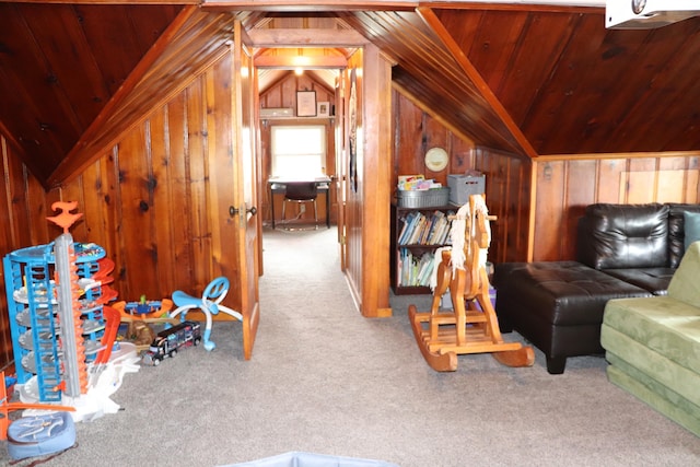 interior space featuring lofted ceiling, carpet flooring, wood walls, and wooden ceiling