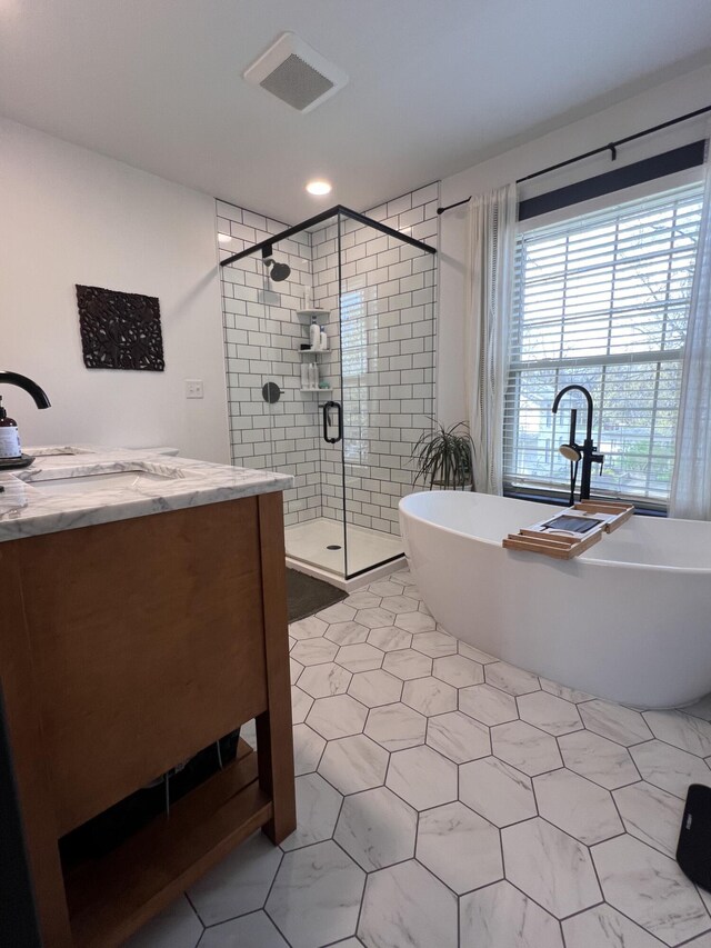 bathroom with tile patterned floors, visible vents, recessed lighting, a freestanding tub, and a shower stall