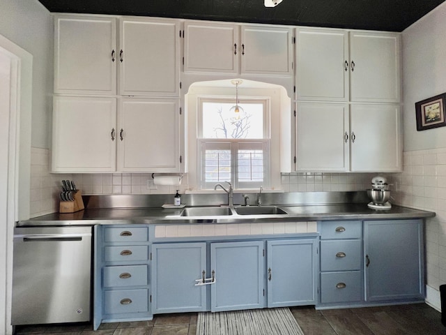 kitchen with stainless steel countertops, dishwasher, white cabinets, and a sink