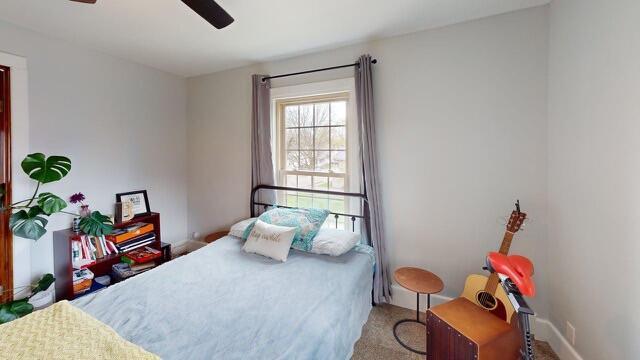 bedroom with carpet floors and a ceiling fan