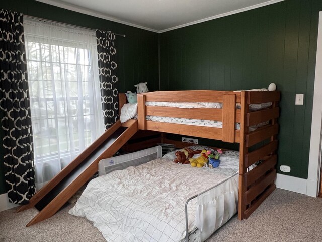 carpeted bedroom with ornamental molding