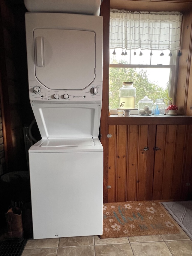 laundry room featuring stacked washer and clothes dryer and laundry area