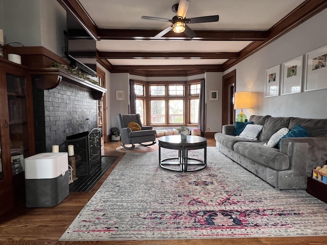 living room with a tile fireplace, beam ceiling, ceiling fan, and dark wood-style flooring