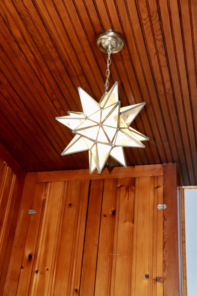 interior details featuring wood ceiling and wood walls
