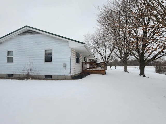 snow covered property featuring a deck