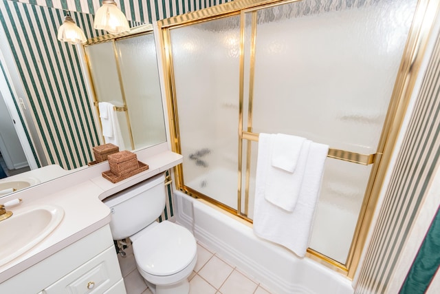 full bathroom featuring vanity, wallpapered walls, tile patterned floors, toilet, and combined bath / shower with glass door