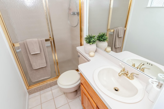 bathroom featuring tile patterned floors, a stall shower, toilet, and vanity