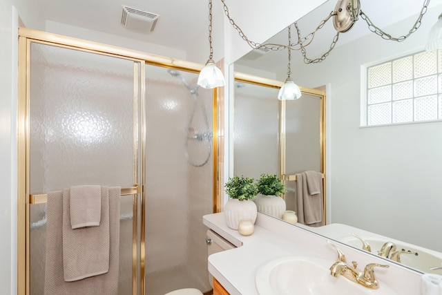 full bathroom featuring visible vents, toilet, a stall shower, and vanity