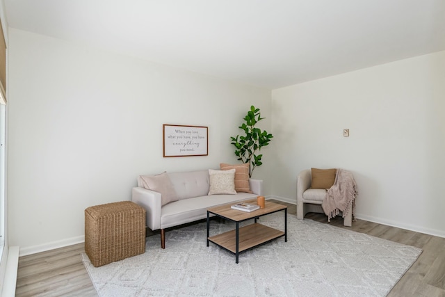 living area with baseboards and light wood-type flooring