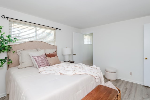 bedroom featuring wood finished floors and baseboards