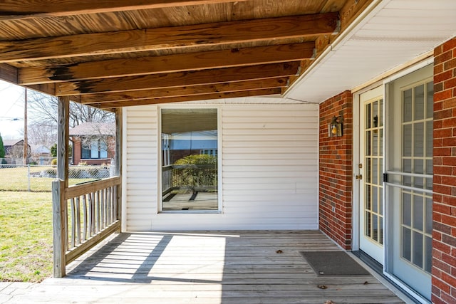 wooden terrace featuring fence