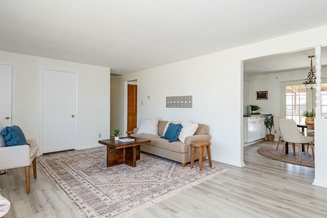 living room featuring baseboards and light wood finished floors